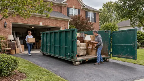 People loading boxes and furniture through the open door of an estate cleanout dumpster