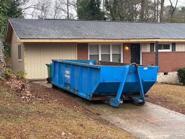 Blue roll-off dumpster on a home's driveway in the Geronimo, OK rental guide