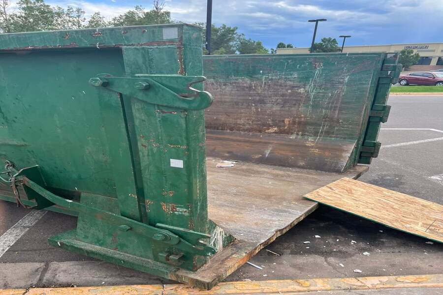 Open rear doors and loading ramp on a roll-off dumpster in the Walters, OK rental guide